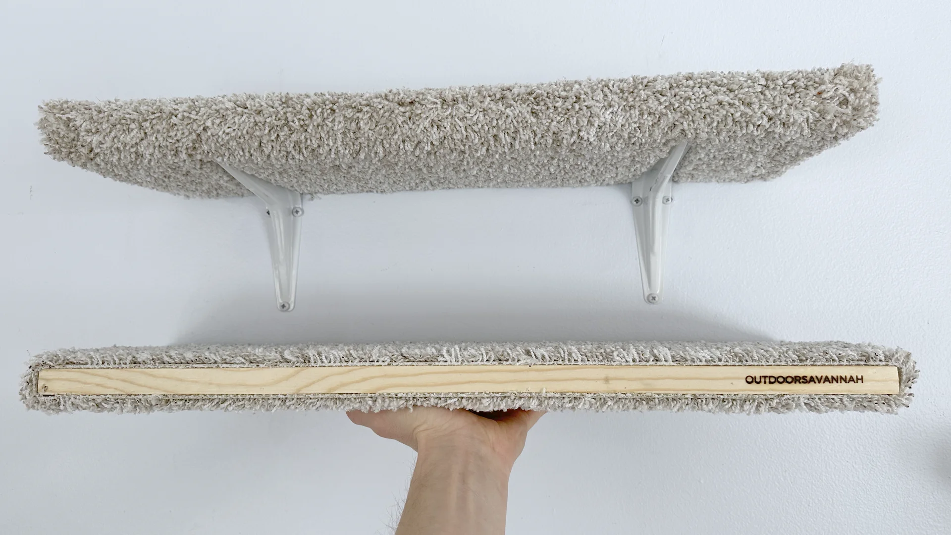 OutdoorSavannah trademarked carpeted cat shelf mounted on the wall with brackets, part of Raja and David DIY cat furniture collection